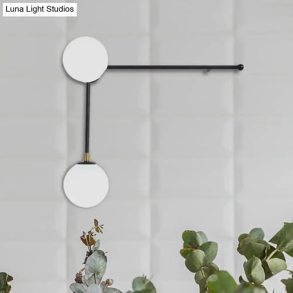 Modern black and gold wall lamp with two white glass shades direct wired electric in sleek modern design