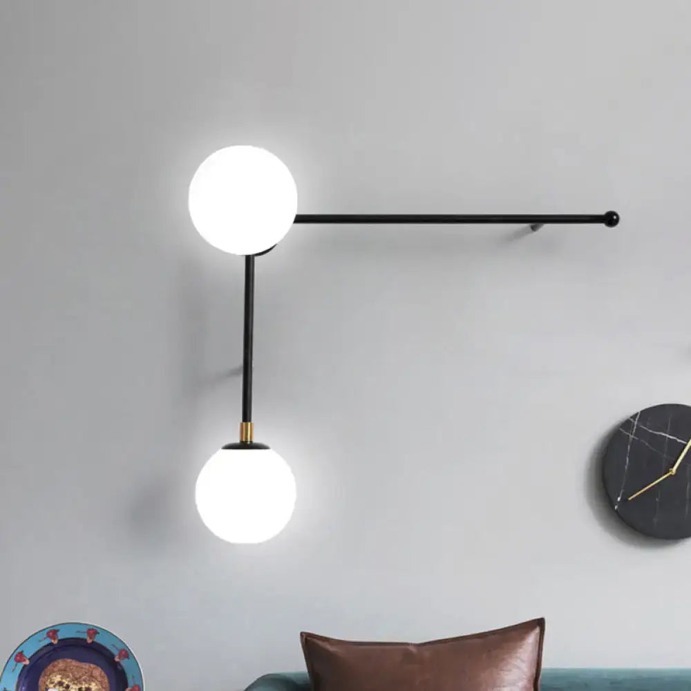 Modern black metal wall lamp with two glowing white glass spheres direct wired electric for bedroom modern design