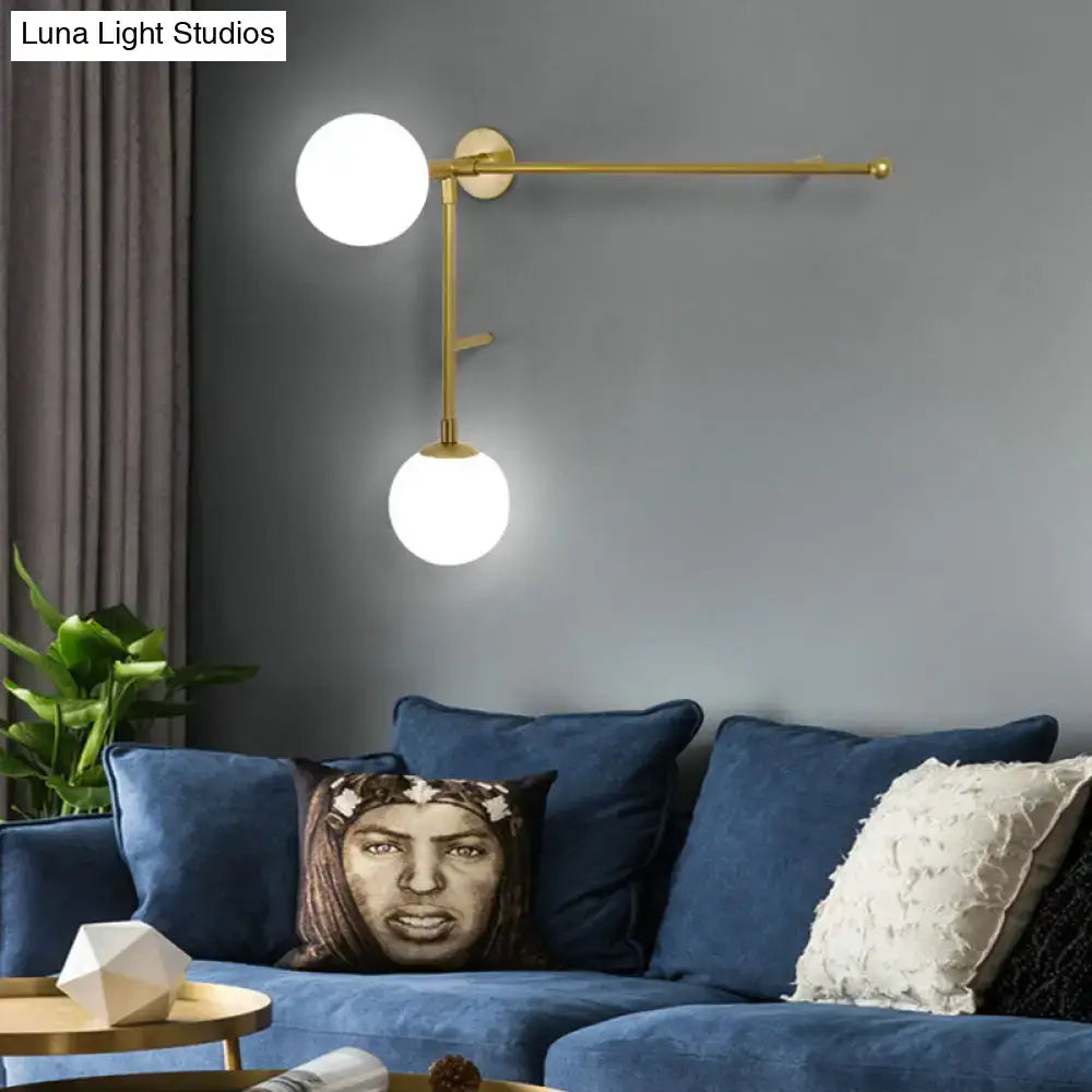 Gold-toned wall lamp with two white glass shades direct wired electric modern design for bedroom use