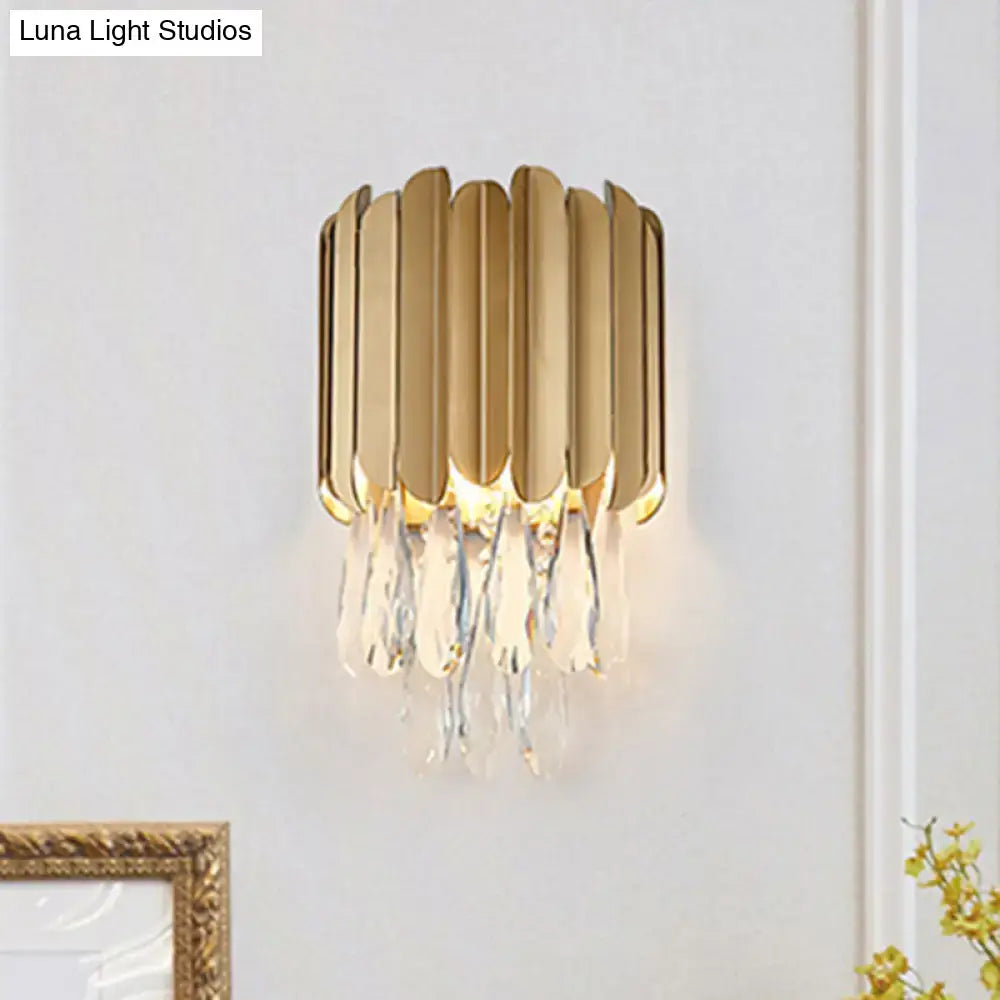 Modern black and gold wall lamp featuring gold-toned fluted metal plates and clear crystal teardrop droplets