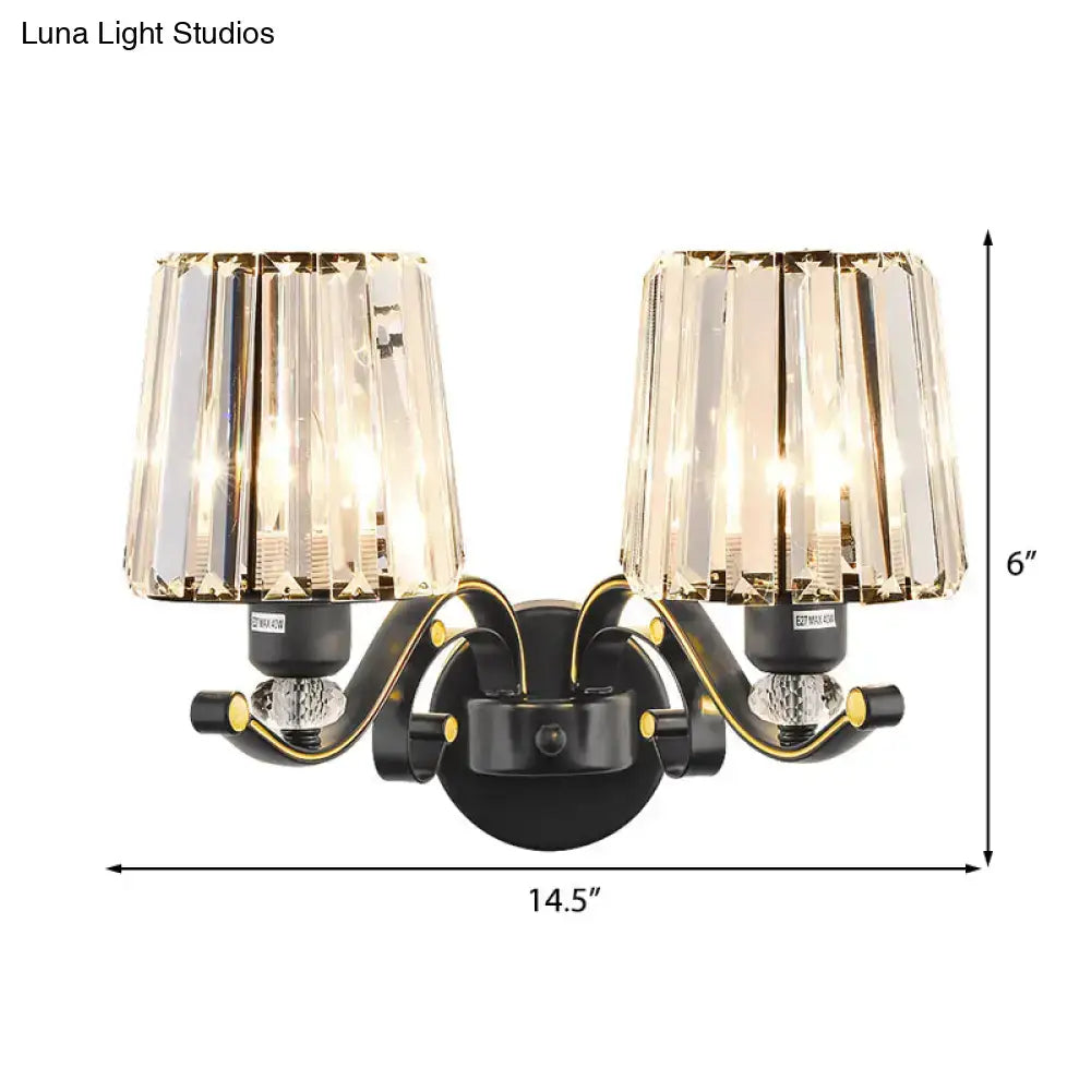 Modern black and gold wall lamp with clear glass crystal shades designed as a two-light bedroom sconce