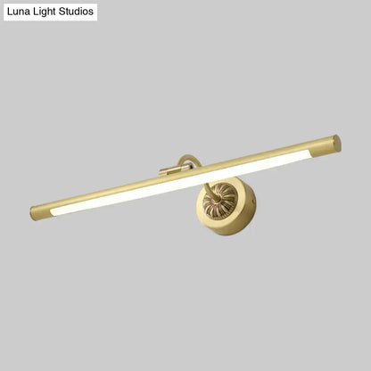 Gold-finished wall light fixture with sleek elongated bar and ornate circular base for bedroom dressing table use