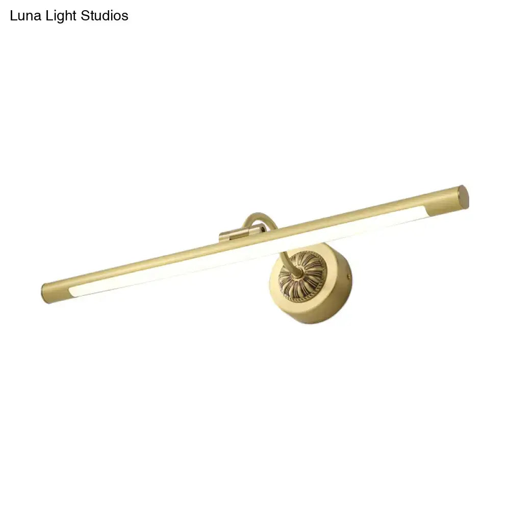 Gold-finished wall light fixture with sleek elongated bar and ornate circular base for bedroom dressing table