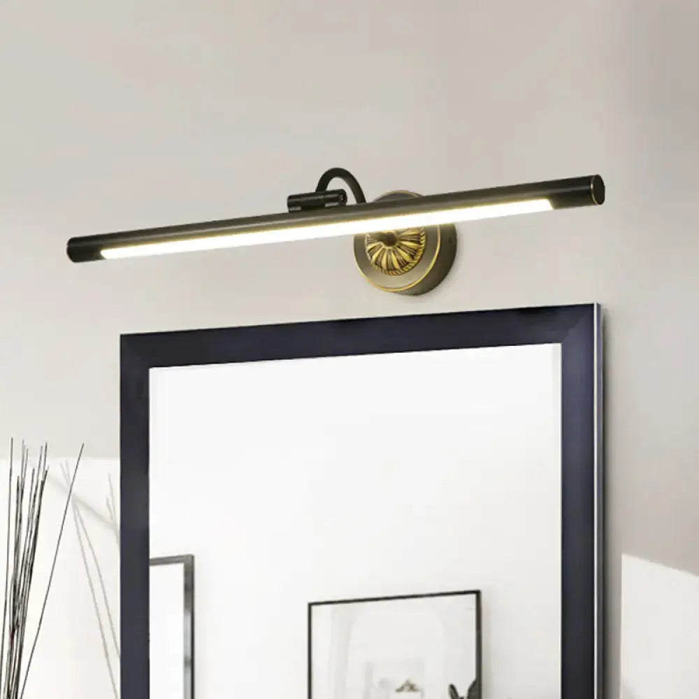 Modern black and gold wall light fixture with matte black cylindrical bar and ornate gold base for dressing table
