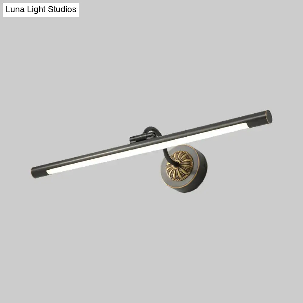 Modern black and gold wall light fixture with matte black cylindrical bar and brass base for dressing table use