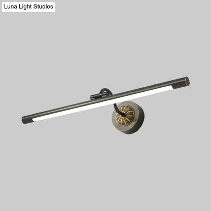 Modern black and gold wall light fixture with matte black cylindrical bar and brass base for dressing table use