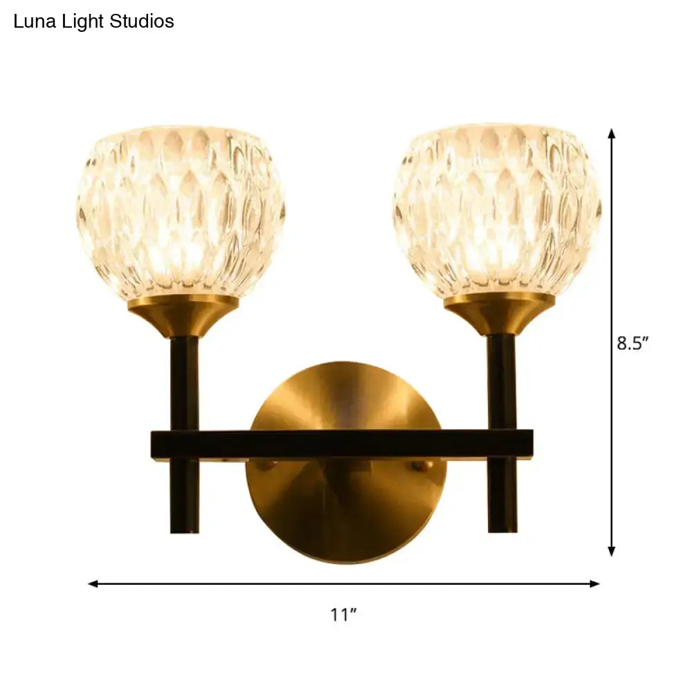 Brass-finished modern wall light with two dimpled glass shades for living room illumination