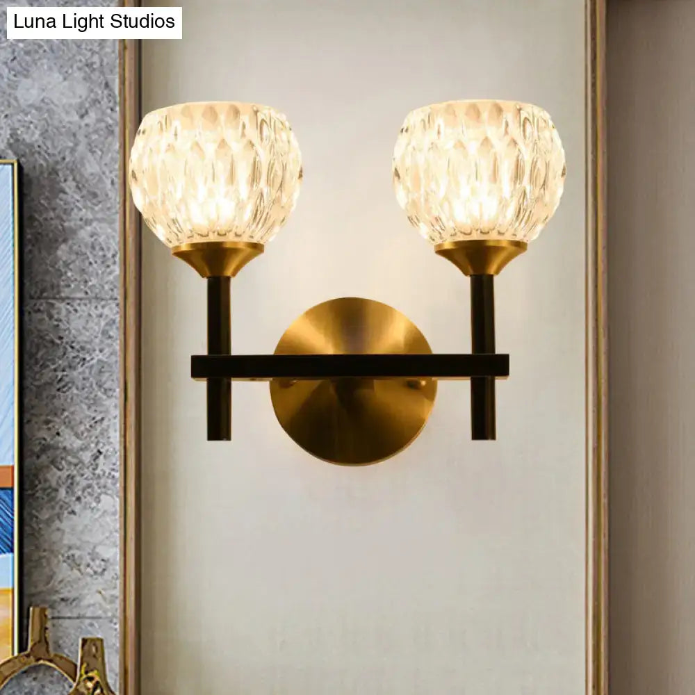 Gold-toned wall light with two faceted dimpled glass shades for living room modern black and gold design