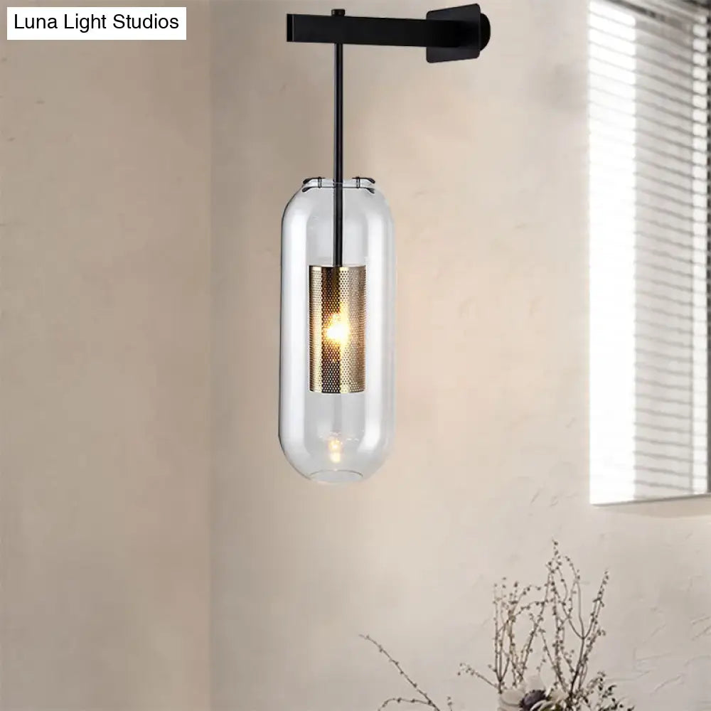 Modern black and gold wall mounted light featuring a clear glass pendant with gold mesh accent and black metal bracket