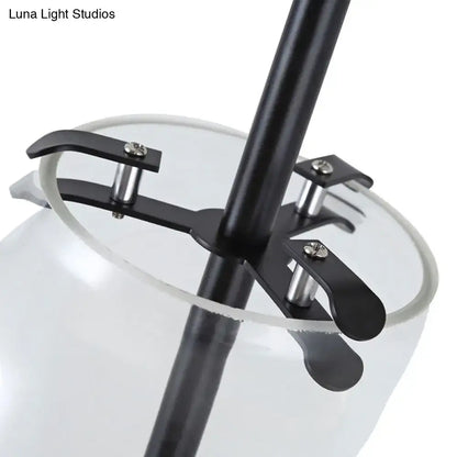 Modern black and gold wall mounted light with black metal fixture and clear glass shade for living room use