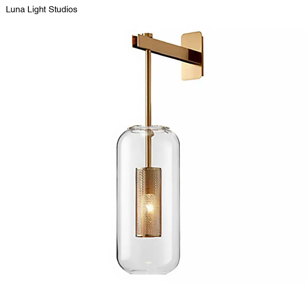 Modern gold-toned wall mounted light with clear glass shade and textured metallic inner cylinder for living room use
