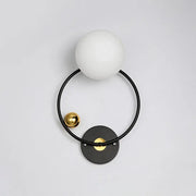 Modern black and gold wall sconce light with opal glass shade featuring a matte white spherical glass and metal frame
