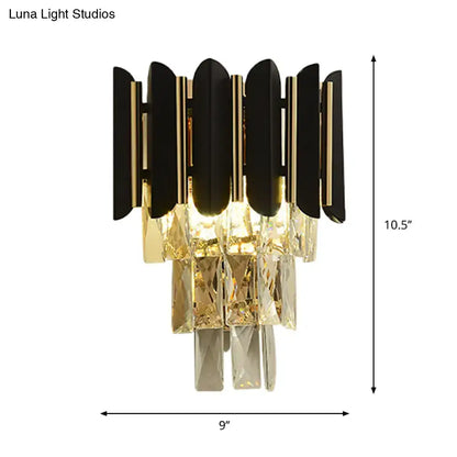 Modern black and gold wall sconce with clear faceted crystals and black finish for bedroom lighting
