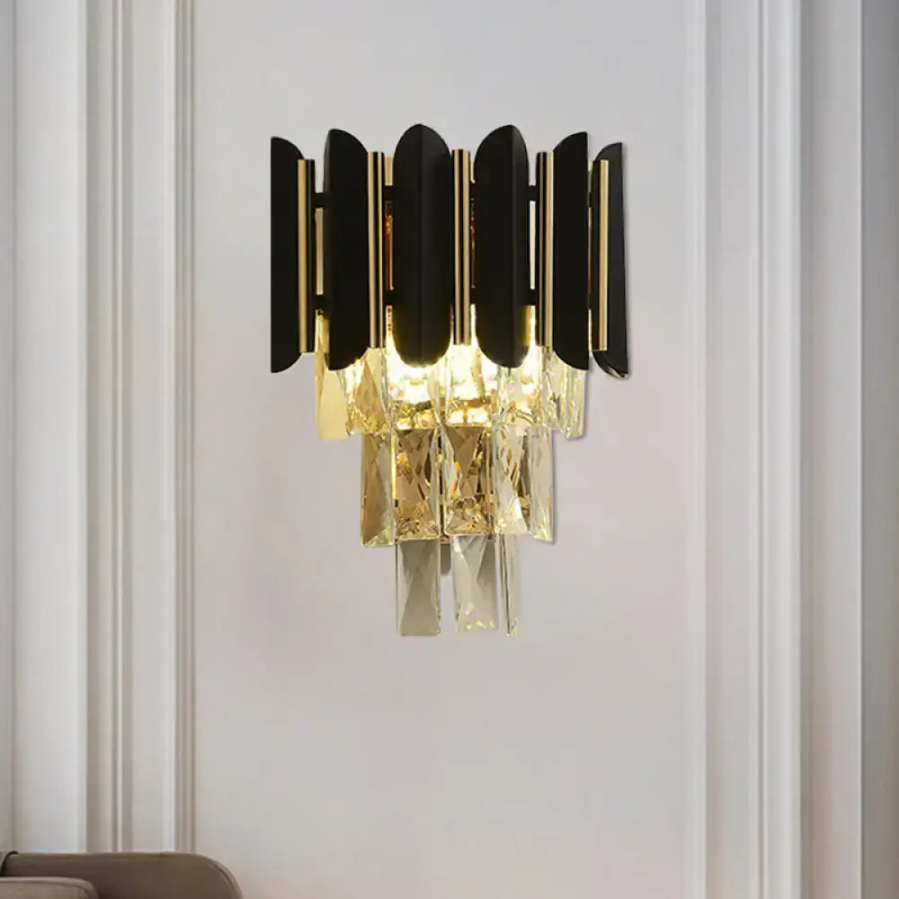 Modern black and gold wall sconce with black finish and clear faceted crystals for bedroom lighting