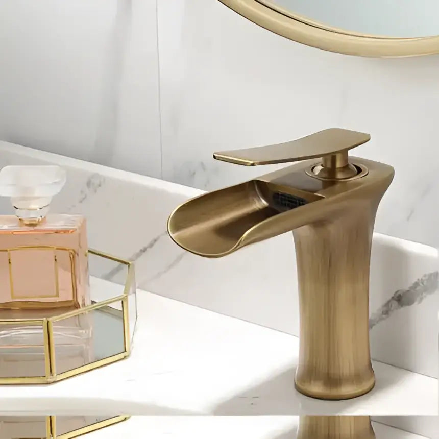 Modern black and gold waterfall basin faucet with sleek brass curved spout ideal for gold waterfall bathroom decorbites