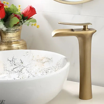 Brass-finished modern black and gold waterfall basin faucet with sleek tall design for gold waterfall bathroom decorbites use