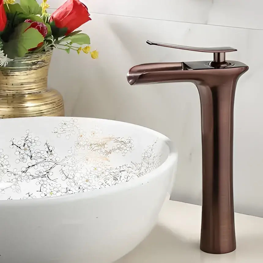 Modern black and gold waterfall basin faucet with bronze finish and single lever handle for gold waterfall bathroom decorbites
