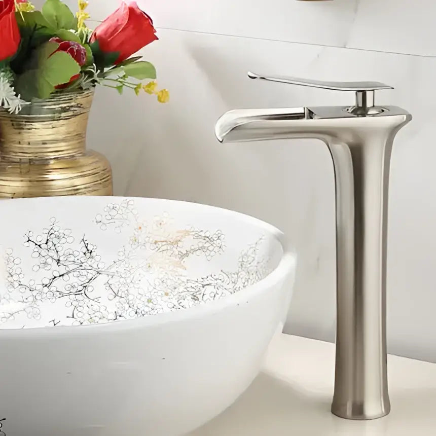 Modern black and gold waterfall basin faucet with brushed stainless steel finish and sleek tall design for bathroom use
