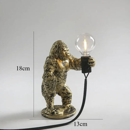 Modern black gorilla night light bedroom resin lamp featuring a gold-finished gorilla figurine holding an exposed bulb