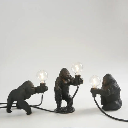 Three black resin gorilla figurine lamps holding glowing bulbs modern decorbites gorilla night light for bedroom