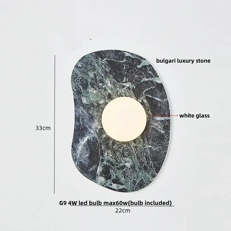 Modern black and green marble wall sconce with a circular white glass center and decorbites green marble stone base
