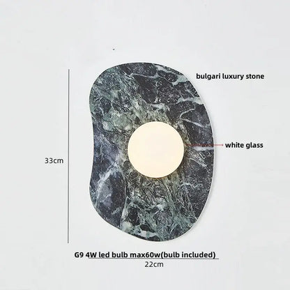 Modern black and green marble wall sconce with a circular white glass center and decorbites green marble stone base