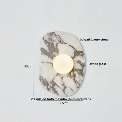 Modern wall sconce with a circular white glass bulb set in irregular decorbites green marble stone base for bedroom use