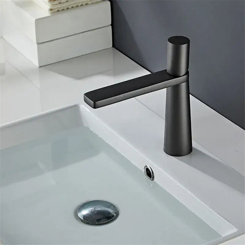 Modern black and grey brass decorbites basin faucet with matte finish and cylindrical minimalist spout for bathroom use