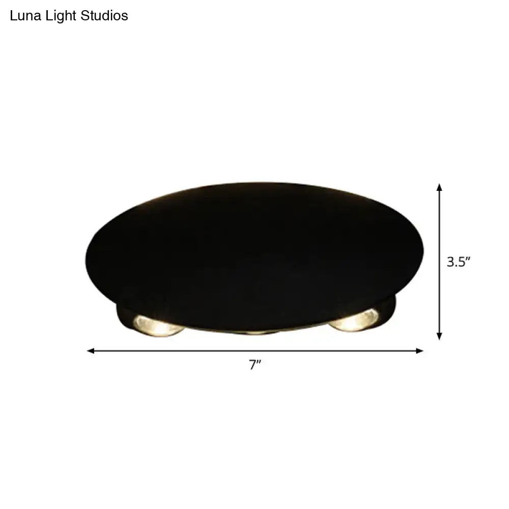 Modern black oval ceiling wall washer sconce with three recessed circular led bulbs for hallway lighting