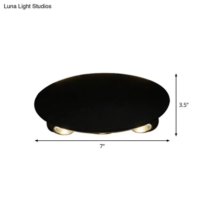 Modern black oval ceiling wall washer sconce with three recessed circular led bulbs for hallway lighting