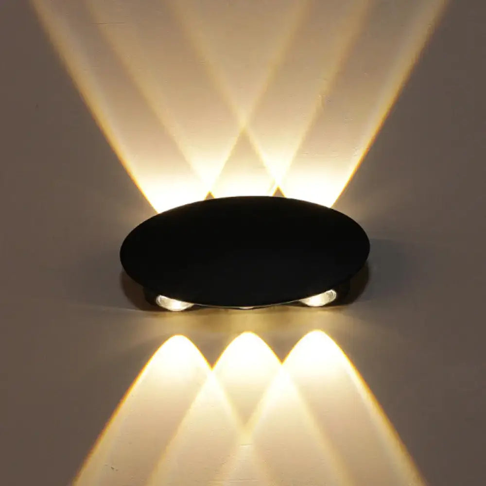 Modern black hexagonal led wall washer sconce with three warm focused light beams casting geometric patterns