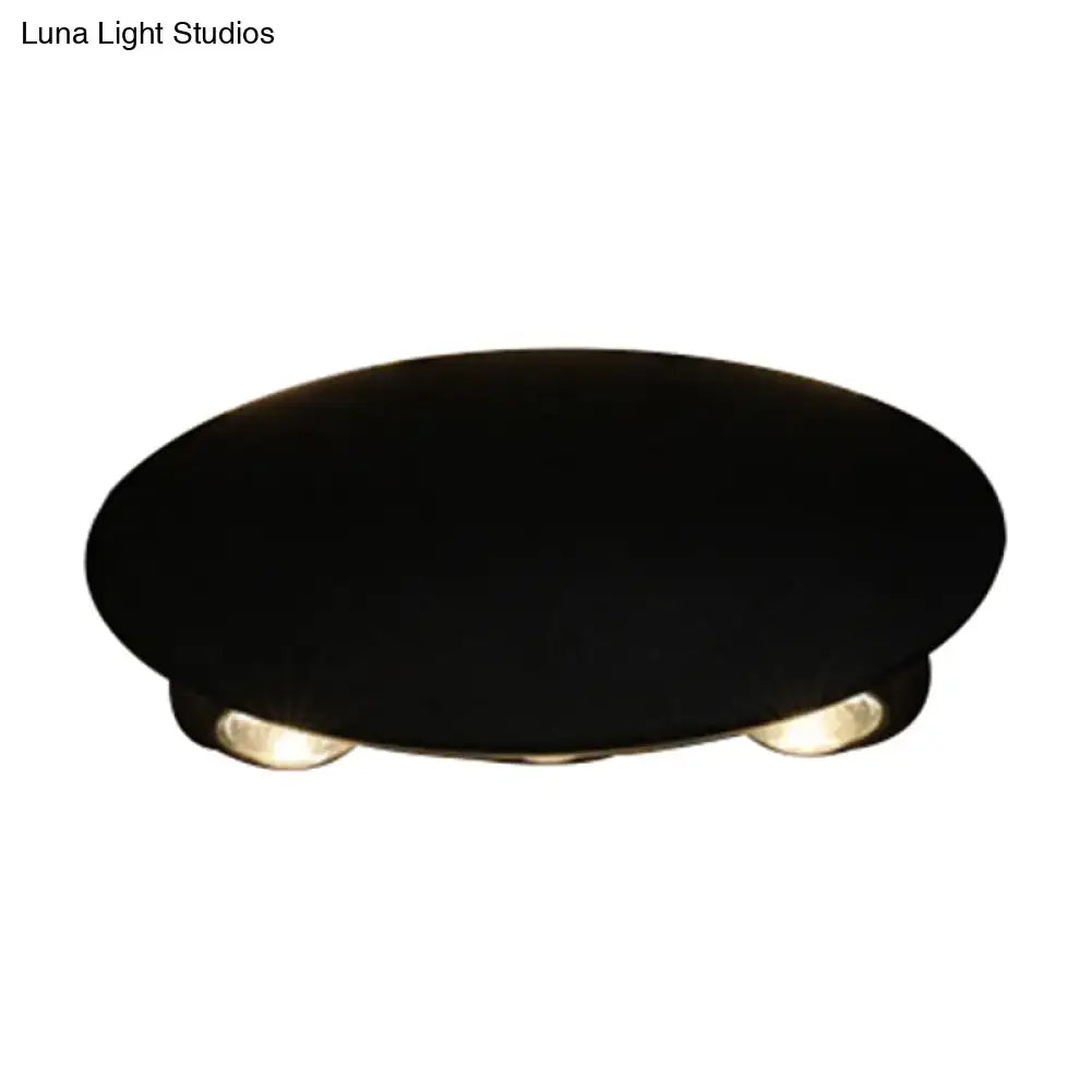 Modern black hexagonal led wall washer sconce with black oval base and two warm-toned led bulbs for hallway lighting