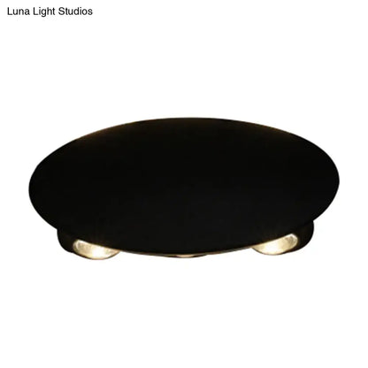 Modern black hexagonal led wall washer sconce with black oval base and two warm-toned led bulbs for hallway lighting