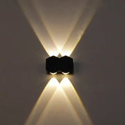 Modern black hexagonal led wall washer sconce with two warm white lights casting symmetrical beams for hallway lighting