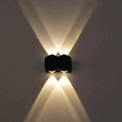 Modern black hexagonal led wall washer sconce with two warm white lights casting symmetrical beams for hallway lighting