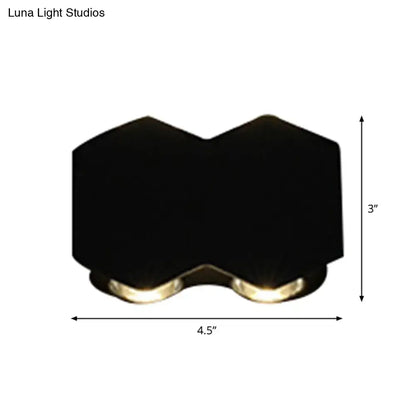 Modern black hexagonal wall washer sconce with two warm-toned led lights for hallway wall light lighting