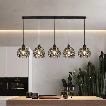 Modern black iron cage pendant lamp with intricate circular design hanging above kitchen island lighting decorbites crystal dining