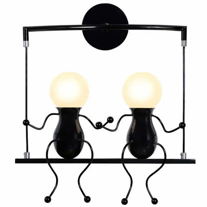 Modern black iron wall sconce with two whimsical hand-holding figures and glowing spherical heads for bedroom decorbites creative led