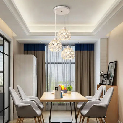 Modern black iron crystal triple pendant lamp with three white spherical lights with circular cutouts for dining room decorbites crystal triple pendant