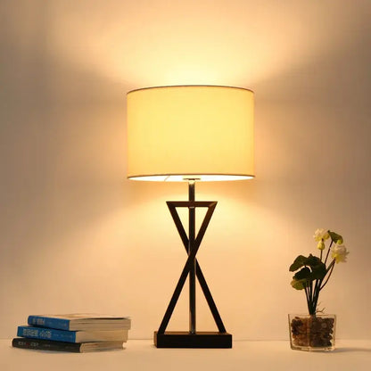 Modern black iron table lamp with cylindrical cream fabric shade ideal for bedroom decorbites iron table lamp