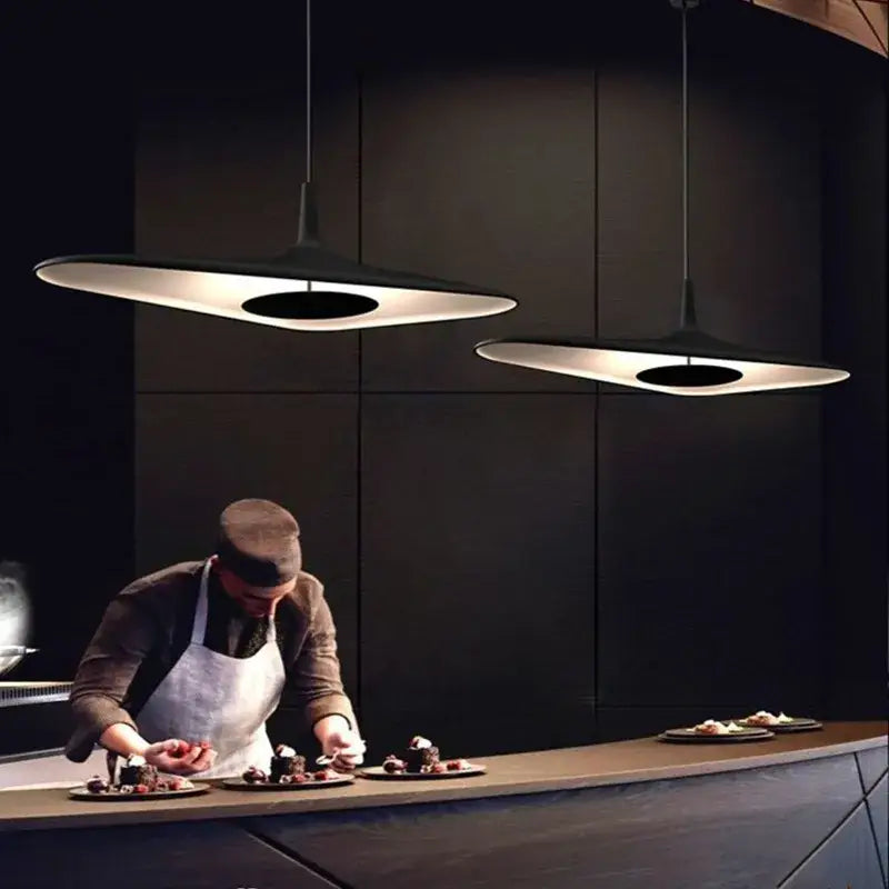 Modern black irregular art pendant lamp with sleek disc-shaped design and warm glow for living room decorbites pendant lamp