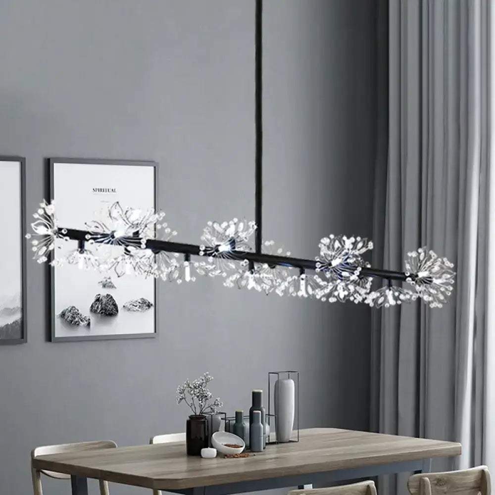 Modern black island pendant light with crystal dandelion clusters hanging above a dining room table