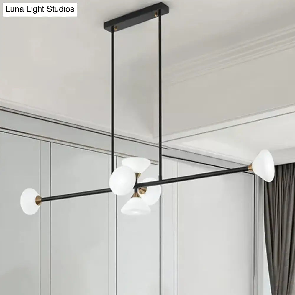 Modern black metal ceiling light with five frosted glass globe shades and brass accents for island pendant use
