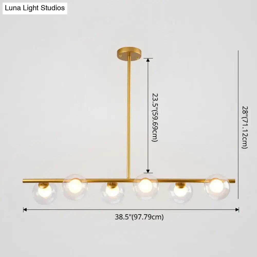 Modern black gold island pendant with clear glass globes and sleek horizontal bar design for dining room lighting