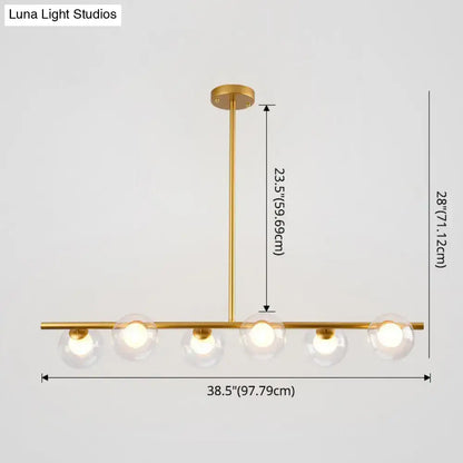 Modern black gold island pendant with clear glass globes and sleek horizontal bar design for dining room lighting