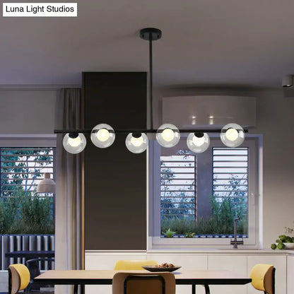 Modern black island pendant chandelier with five clear glass globes featuring black gold metal accents for dining room use