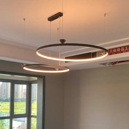 Modern black italian style led pendant light with circular design and warm illumination for living room use