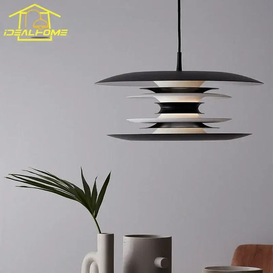 Modern black layered iron art flying pendant light with sleek tiered design and warm glow for dining room decorbites iron art