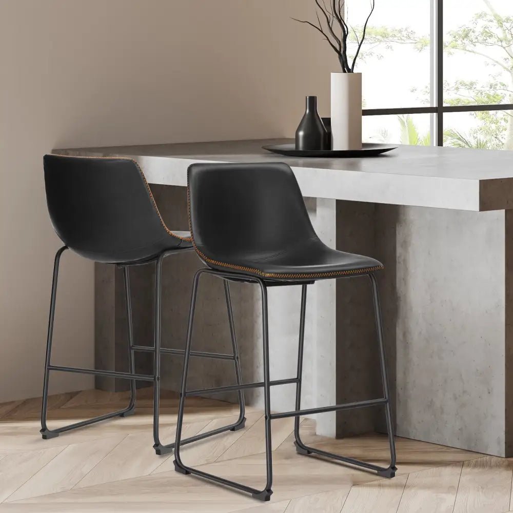 Modern black leather bar stools with gold stitching for kitchen island - Decorbites