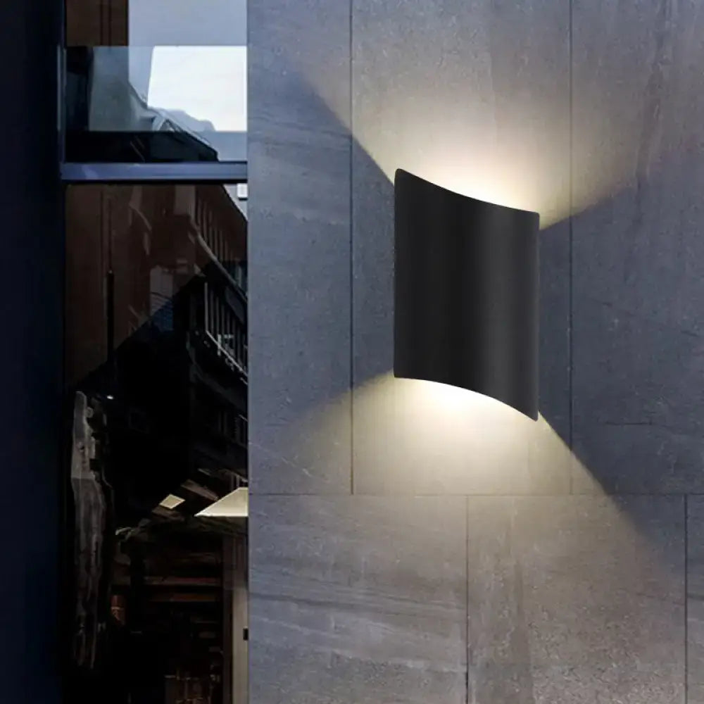 Modern black led outdoor wall sconce featuring a sleek curved design as a stylish light fixture for patios